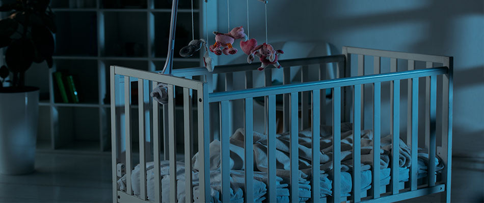 A dimly lit nursery featuring a baby's crib, the soft glow creating a peaceful nighttime environment suitable for sleep.